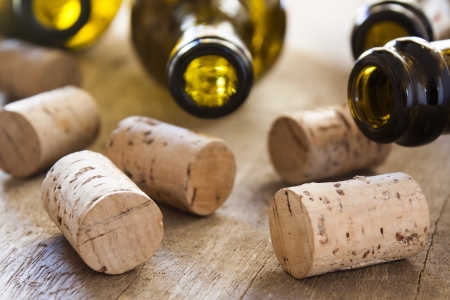 bottles and corks on wooden tableの写真素材