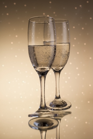 Flutes of champagne in holiday with abstract lights on backgroundの写真素材