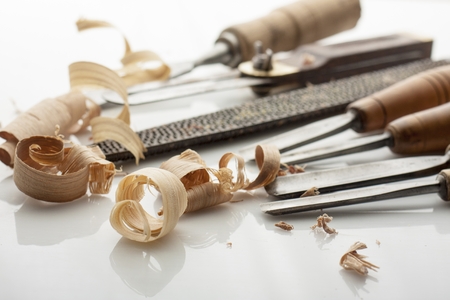 woodworker tools  and shavings on white bord
