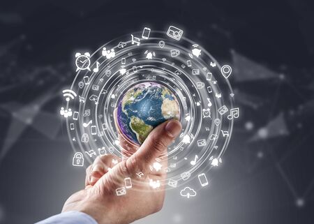 Businessman holding globe with social media network icons structureの写真素材