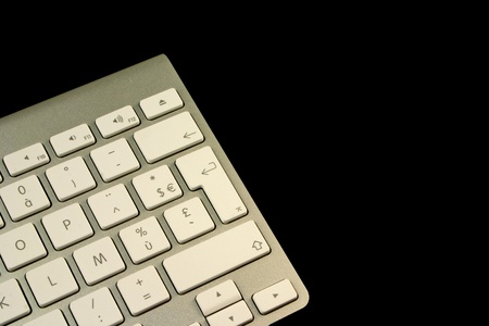 Detail of a silver aluminium keyboard on a black background