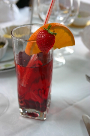 Red cocktail with orange and strawberryの写真素材