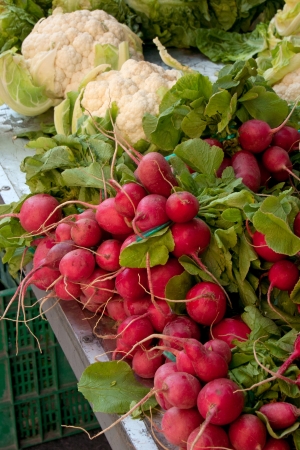 radishes and cauliflower at the local marketの写真素材