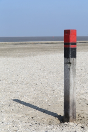 Wooden pole at the beach in Texel - Netherlandsの写真素材