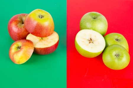 Red and Green apples on colored surfaceの写真素材