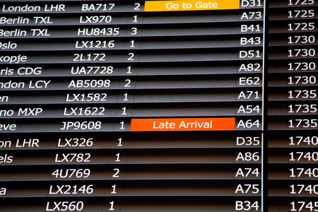 Airport departure board in terminal with flight information