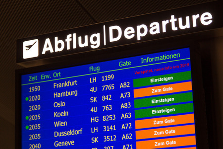 Airport departure board in terminal with flight informationのeditorial素材
