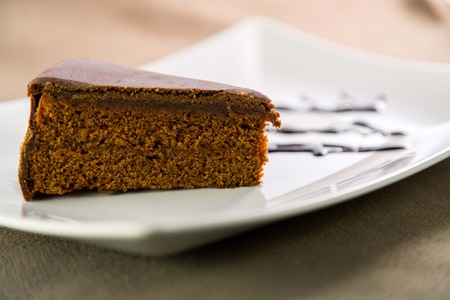 The famous Sacher Cake from Vienna on a white plateの写真素材