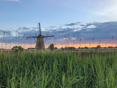 Beautiful dutch windmill landscape at the famous Kinderdijk canalsの写真素材