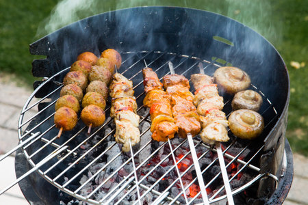 Grilled meat on a summer barbecue in the gardenの写真素材