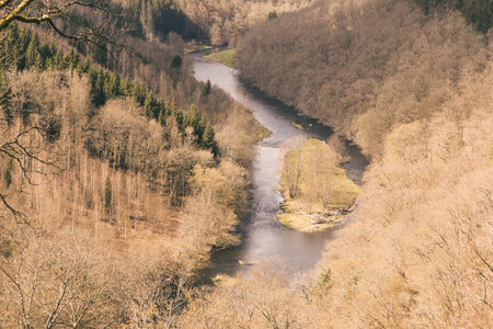 Capturing the tranquil beauty of Ardennes, Belgium, this photograph reveals the enchanting embrace of the Ourthe River, inviting viewers to immerse themselves in the serene landscapes of this picturesque region.の写真素材