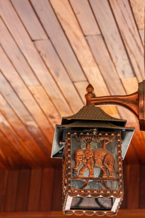 Old lamp on the ceiling of a wooden house. Selective focus.の写真素材