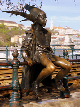 Metal statue of young boy in Budapest near to river, Hungaryの写真素材