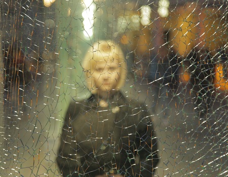 girl thought the broken glass at nightの写真素材