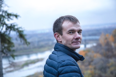 Man ls looking back in a forest at autumnの写真素材