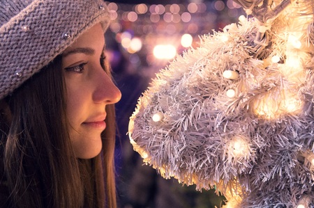 girl at the christmas fair at eveningの写真素材