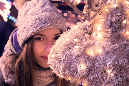 girl at the christmas fair at eveningの写真素材