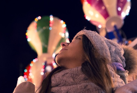 girl at the christmas fair at eveningの写真素材