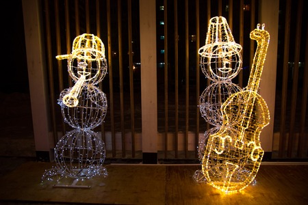 the snowman light installation in a parkの写真素材