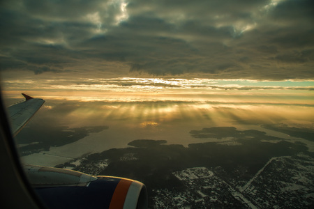 sky through aircraft window onto jet engineの写真素材