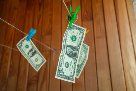 Money is dried on clothespinsの写真素材
