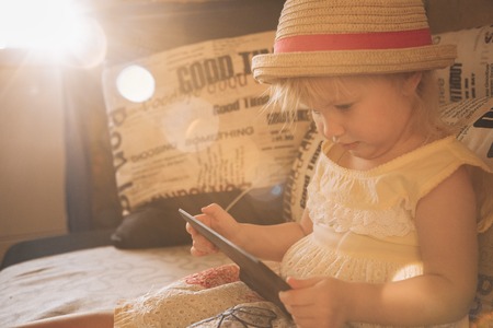 Little girl playing in gadgetの写真素材