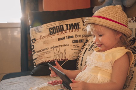 Little girl playing in gadgetの写真素材