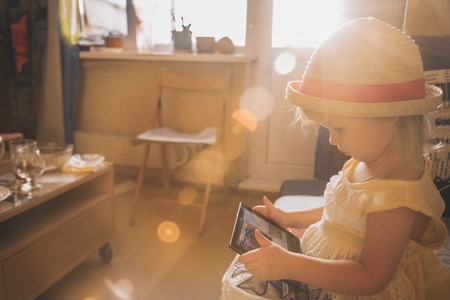 Little girl playing in gadget