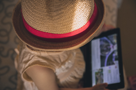Little girl playing in gadgetの写真素材