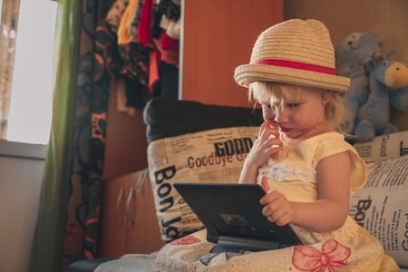 Little girl playing in gadgetの写真素材