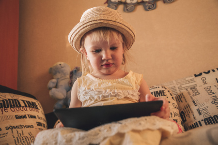 Little girl playing in gadget