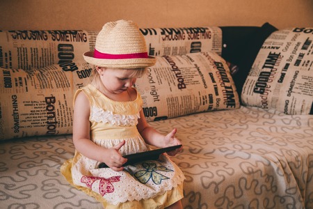 Little girl playing in gadgetの写真素材