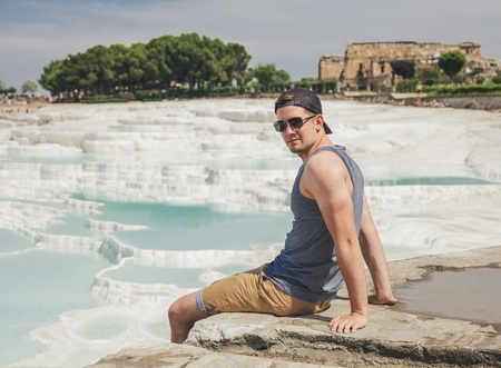 Man seat on the rock in a seaの写真素材