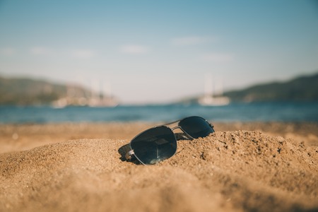 Sunglasses on the beachの写真素材