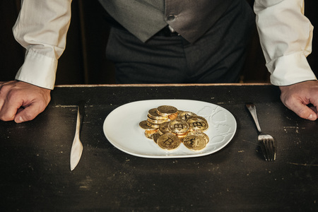 bitcoin in a man's hand in a classic suitの写真素材