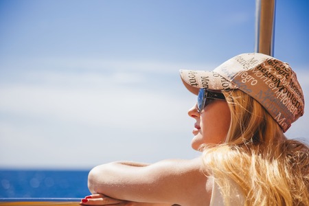 beautiful girl walking along the seashore in the summer dayの写真素材
