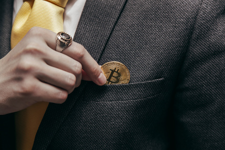 a man holds an enlarged box with bitcoinの写真素材