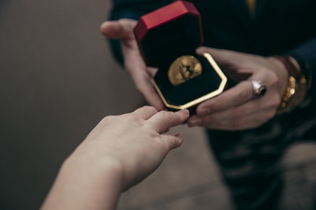 a man holds an enlarged box with bitcoinの写真素材
