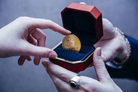 a man holds an enlarged box with bitcoinの写真素材