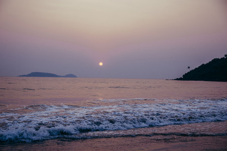 sea waves at sunset in the tropicsの写真素材