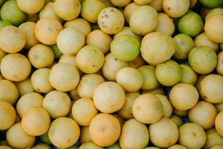 lemons and lime in a large wicker basket on the market in Indiaの写真素材