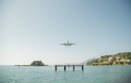 the plane is landing to the airport of Corfu at summer dayの写真素材