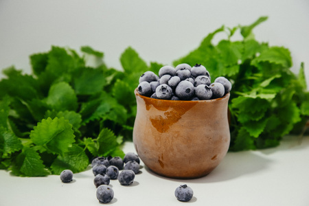 frozen blueberries in a clay cupの写真素材