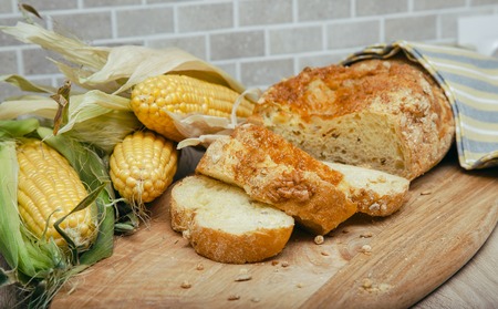 Corn bread on a wooden board with corrugated cornの写真素材