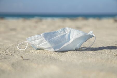 Medical protective mask for coronavirus protection on the  beach in a tropical country at summer dayの写真素材