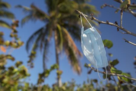 Medical protective mask for coronavirus protection on the  beach in a tropical country at summer dayの写真素材