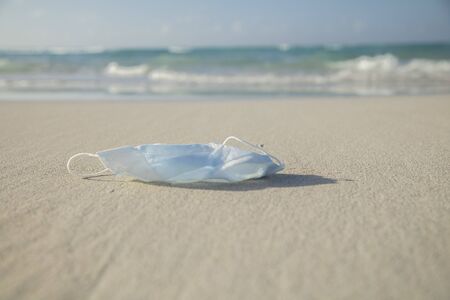 Medical protective mask for coronavirus protection on the  beach in a tropical country at summer dayの写真素材