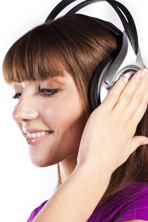 Pretty woman listening, and enjoying musicの写真素材
