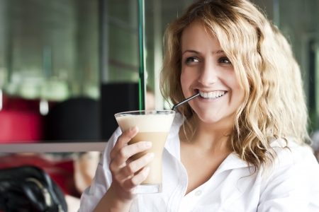 Beautiful woman in street cafe ,with cupの写真素材