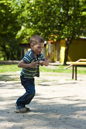 Happy kid playing in streetの写真素材